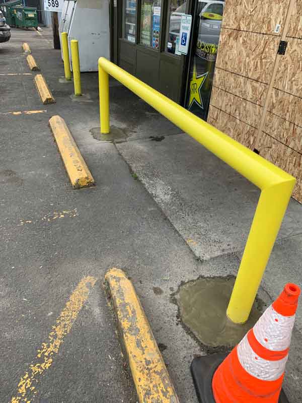 Evergreen Machine Works steel bollards installed in front of convenience store